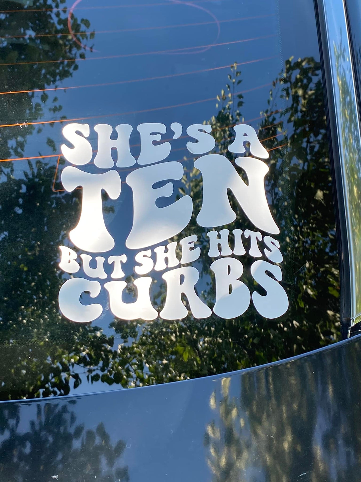 She's a ten but she hits curbs car decal